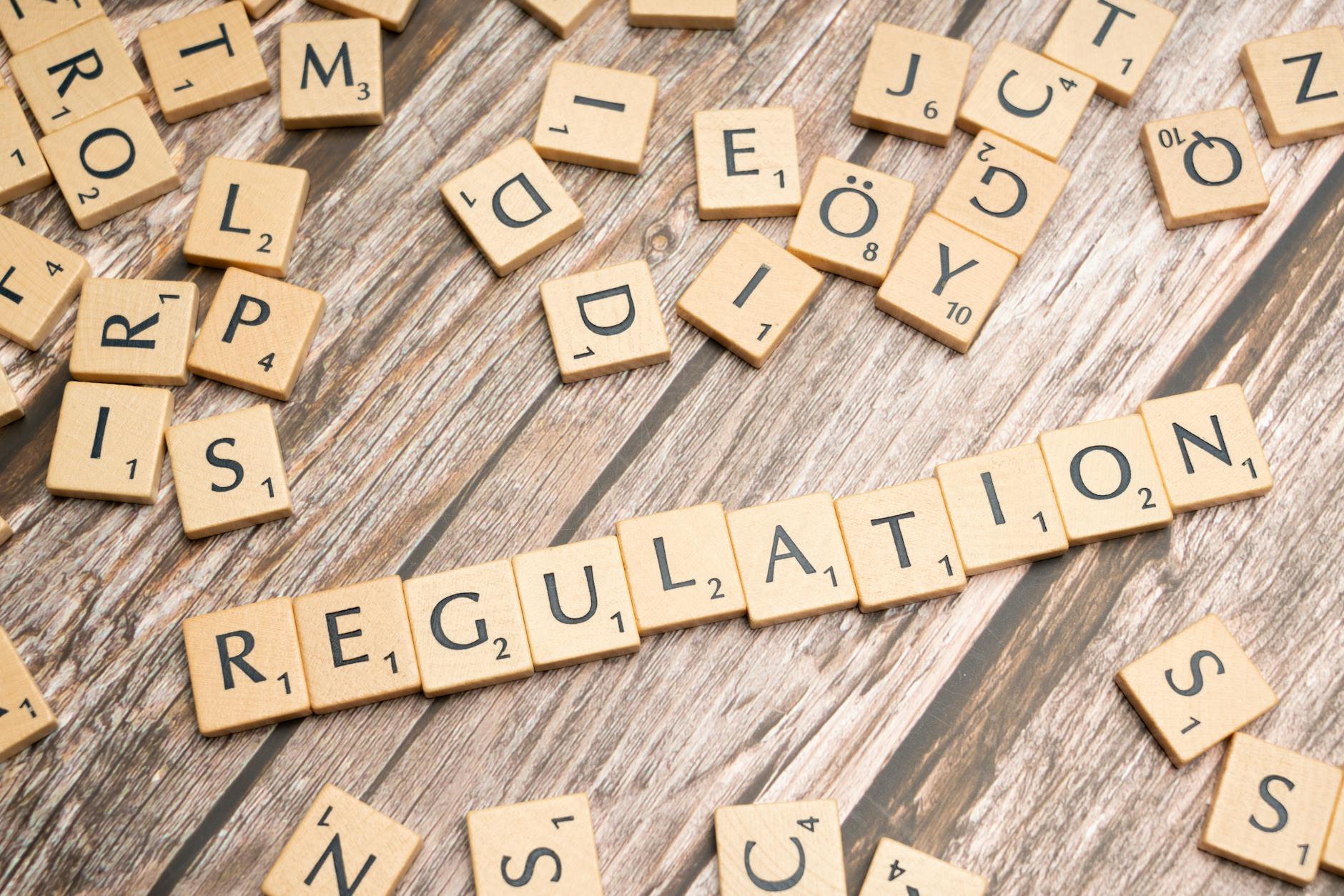 scrabble letters spelling the word regulation